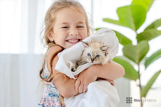 girl drying a cat